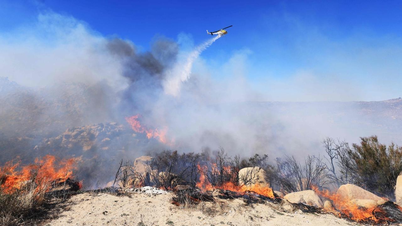 A firefighter walks toward flames as the Highland Fire burns in Aguana, California. Pics/AFP (Text-AP)