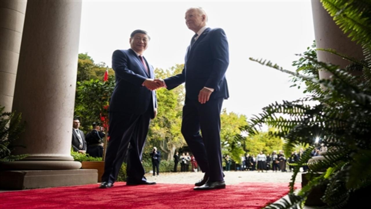 Biden arrived first and awaited Xi, who got out of a black car and took Biden's hand before the two leaders walked a red carpet through the estate's grand entrance with a China flag on one side and a US flag on the other. Five Marines stood in formation.