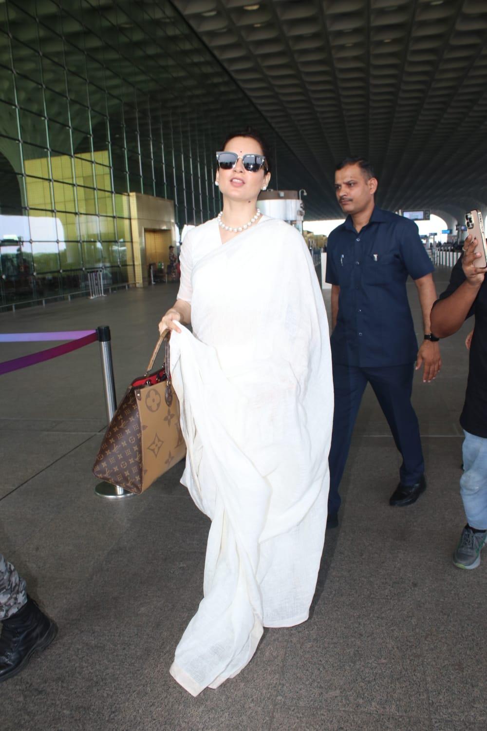 Kangana Ranaut opted for a simple white saree as she jetted off