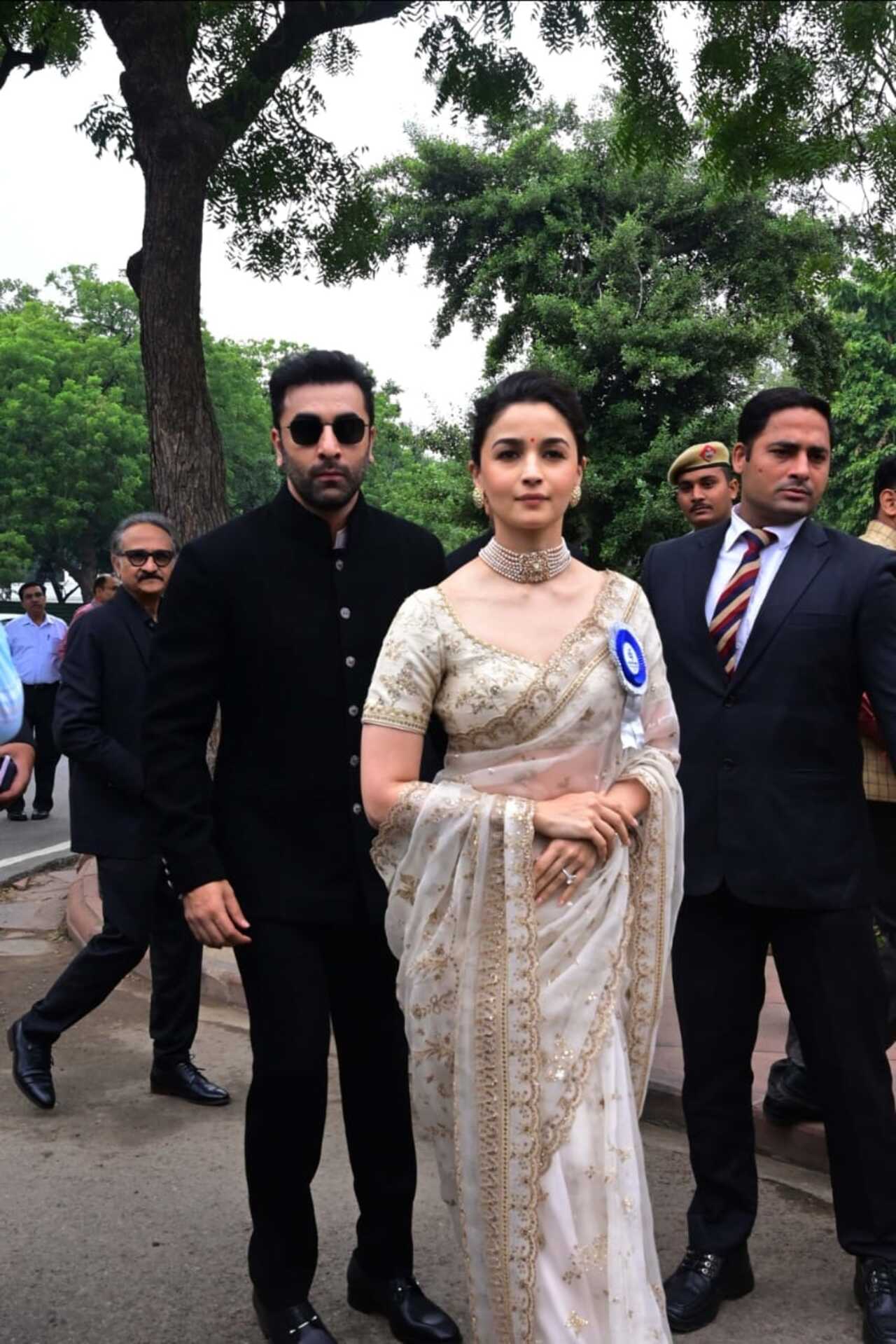 For the occasion, Alia chose a beautiful cream saree heavily decorated with golden borders, and it was not just any other saree but the same one she wore on her wedding day. Ranbir complemented his wife in a black button-up suit