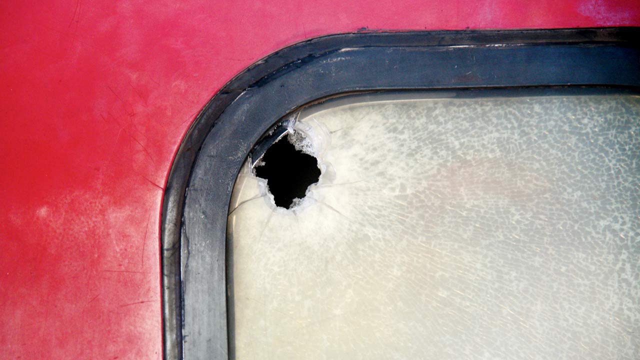 A bullet hole on the window of the  B5 compartment of the express train. File Pic/Pradeep Dhivar
