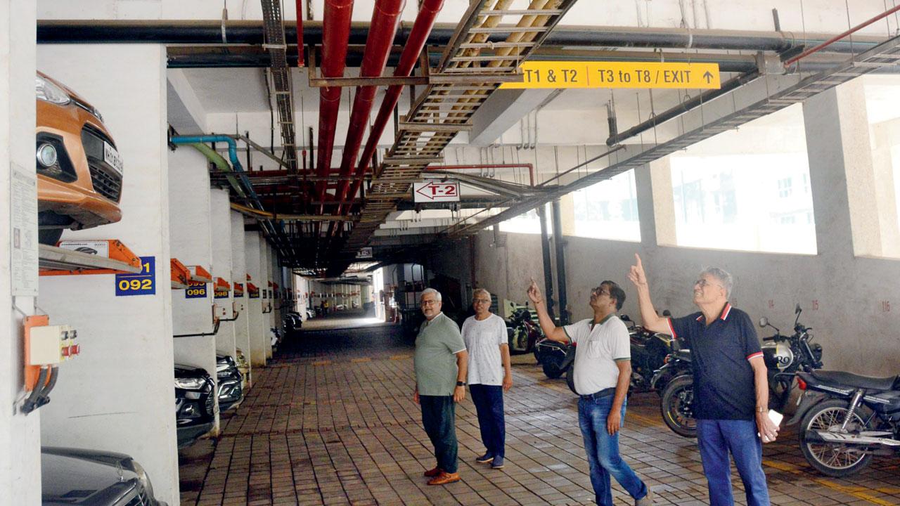 (From left) Committee members Shrikant Gupta, Milind Khanolkar, Pravin Mendon and Dr Vijay Sangole point to the rainwater harvesting pipes