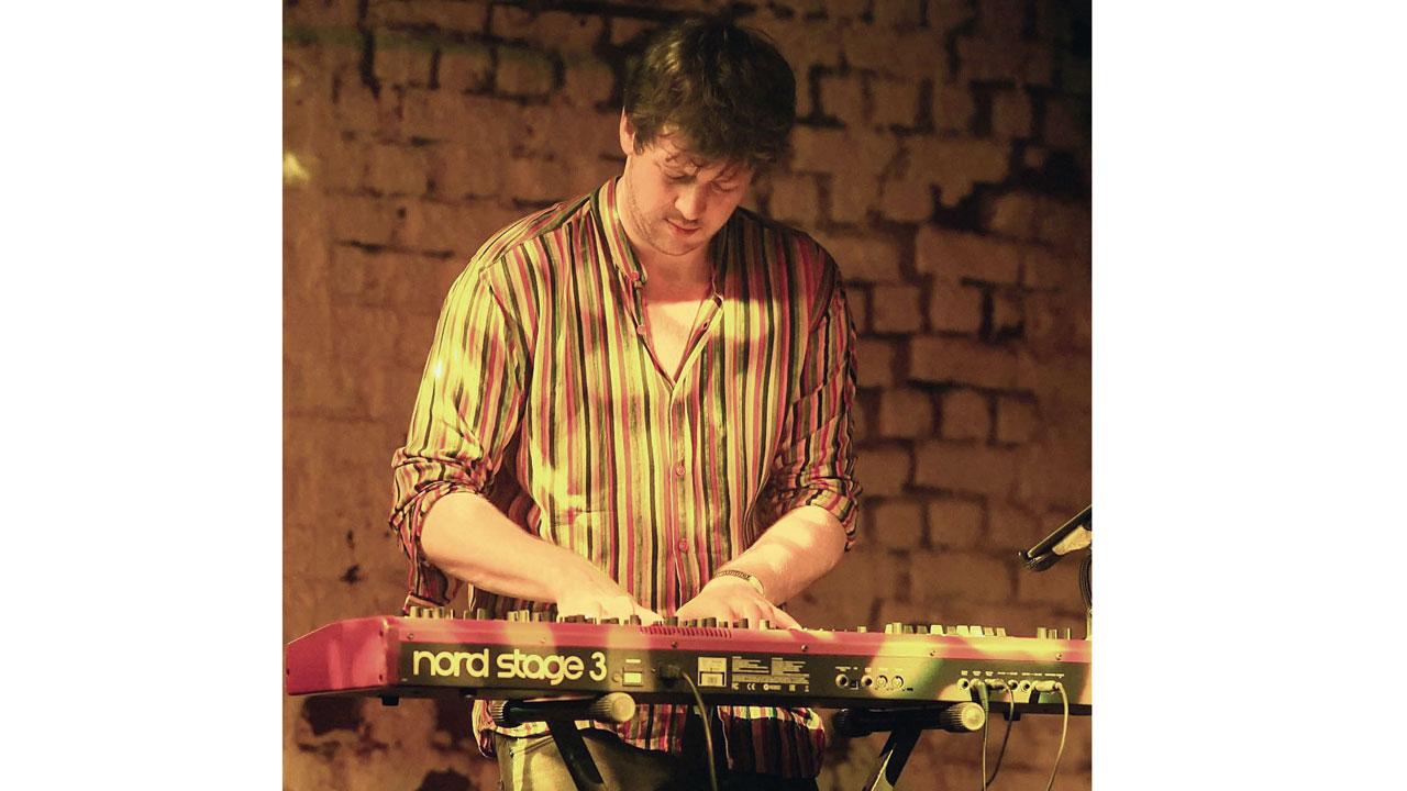 Pianist Clement Rooney plays the keyboard at a performance