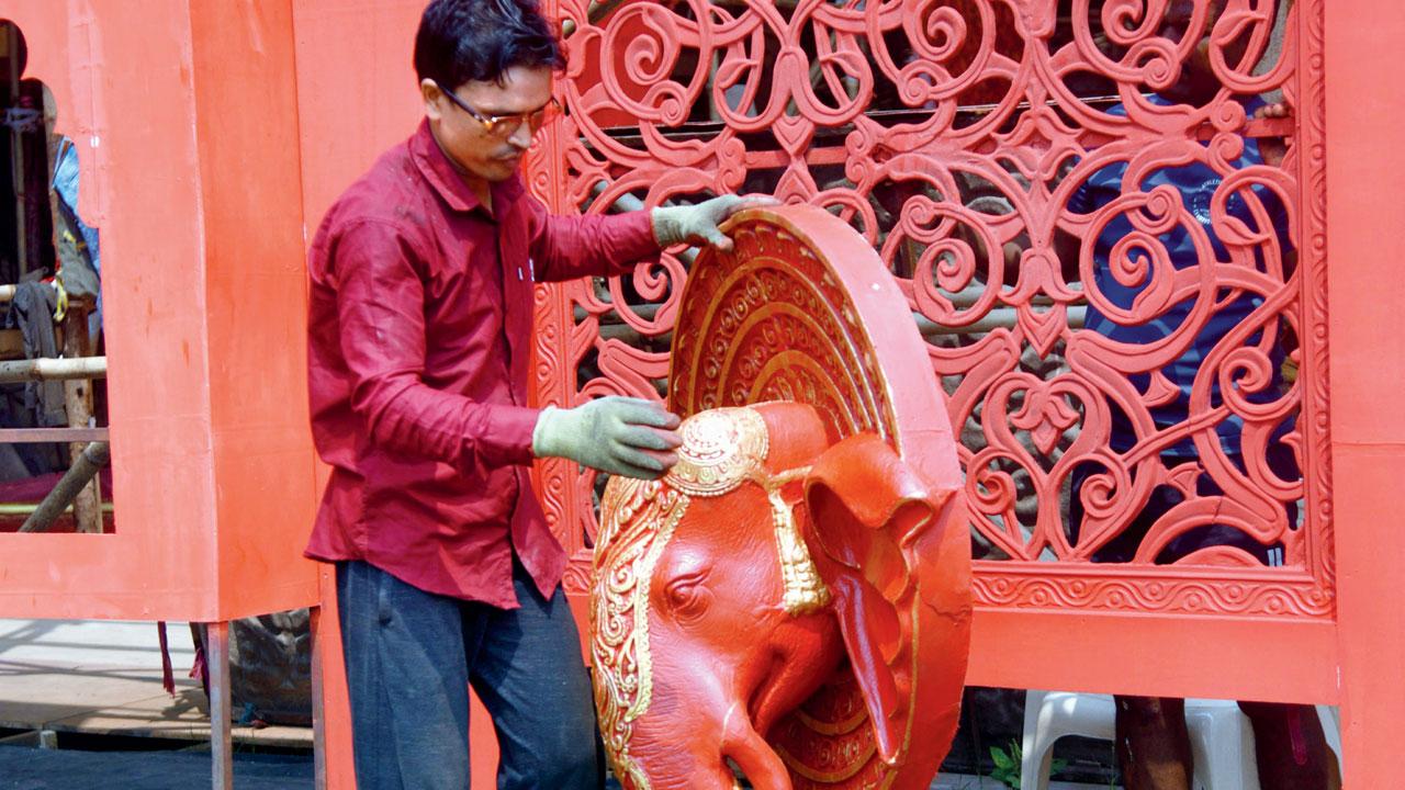 A craftsman inspects a sculpture at the Bengal Club’s Durga Puja pandal in Shivaji Park, Dadar on Friday. Pic/Pradeep Dhivar