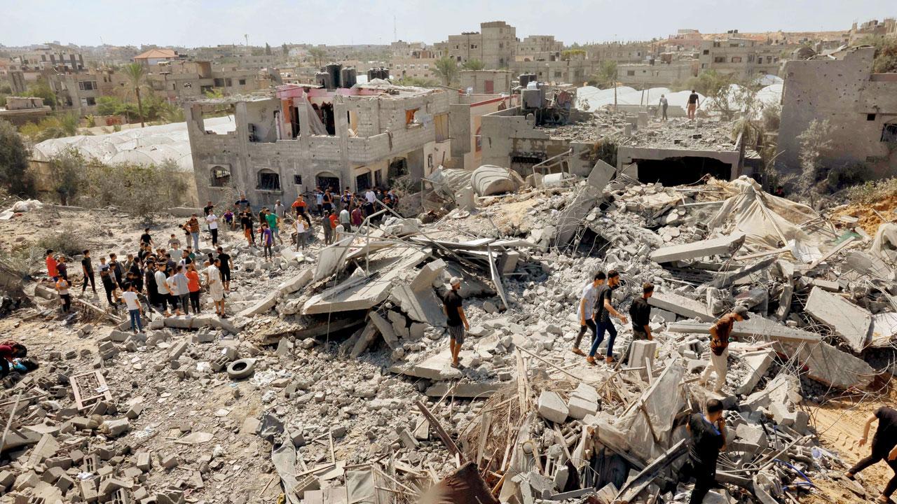Palestinian search the rubble of destroyed buildings. Pic/AP