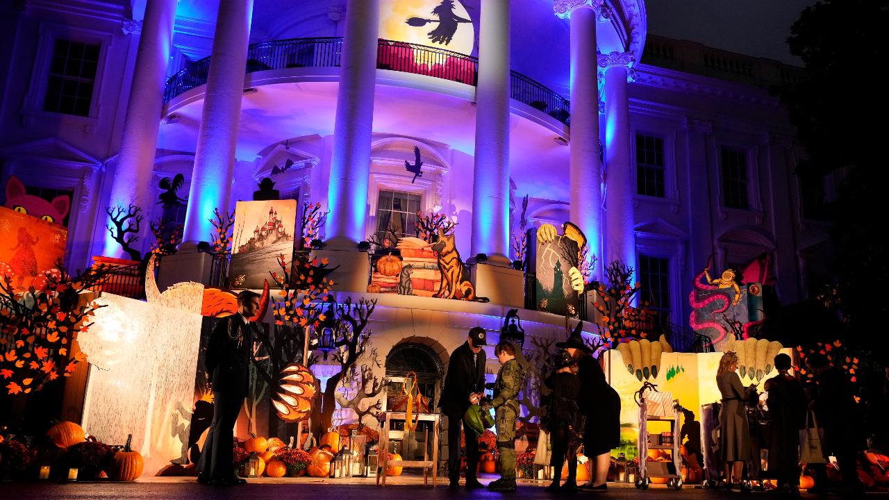 President Joe Biden and first lady Jill Biden give treats to trick-or-treaters on the South Lawn of the White House, on Halloween.