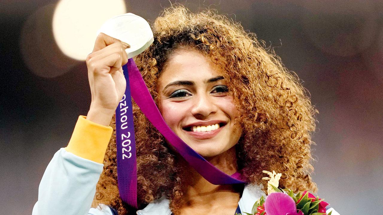 India’s Harmilan Bains with her 800m silver medal yesterday. Pics/PTI