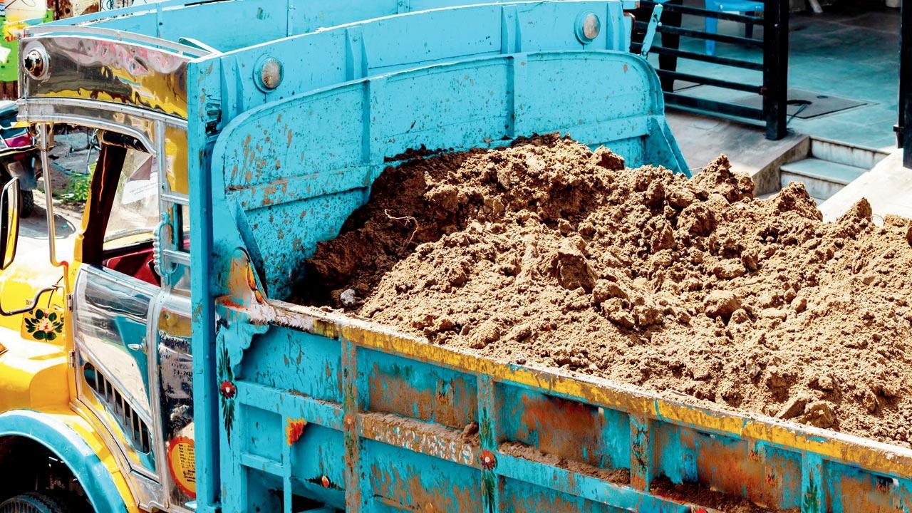 Uncovered trucks ferrying material contribute to the dust in the air. Representation pic
