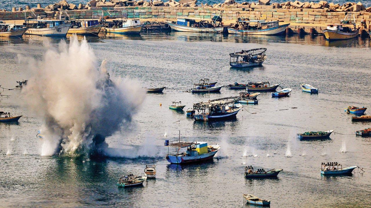 Shells from Israeli bombardment land in the water in the Gaza City seaport. Pic/AP 