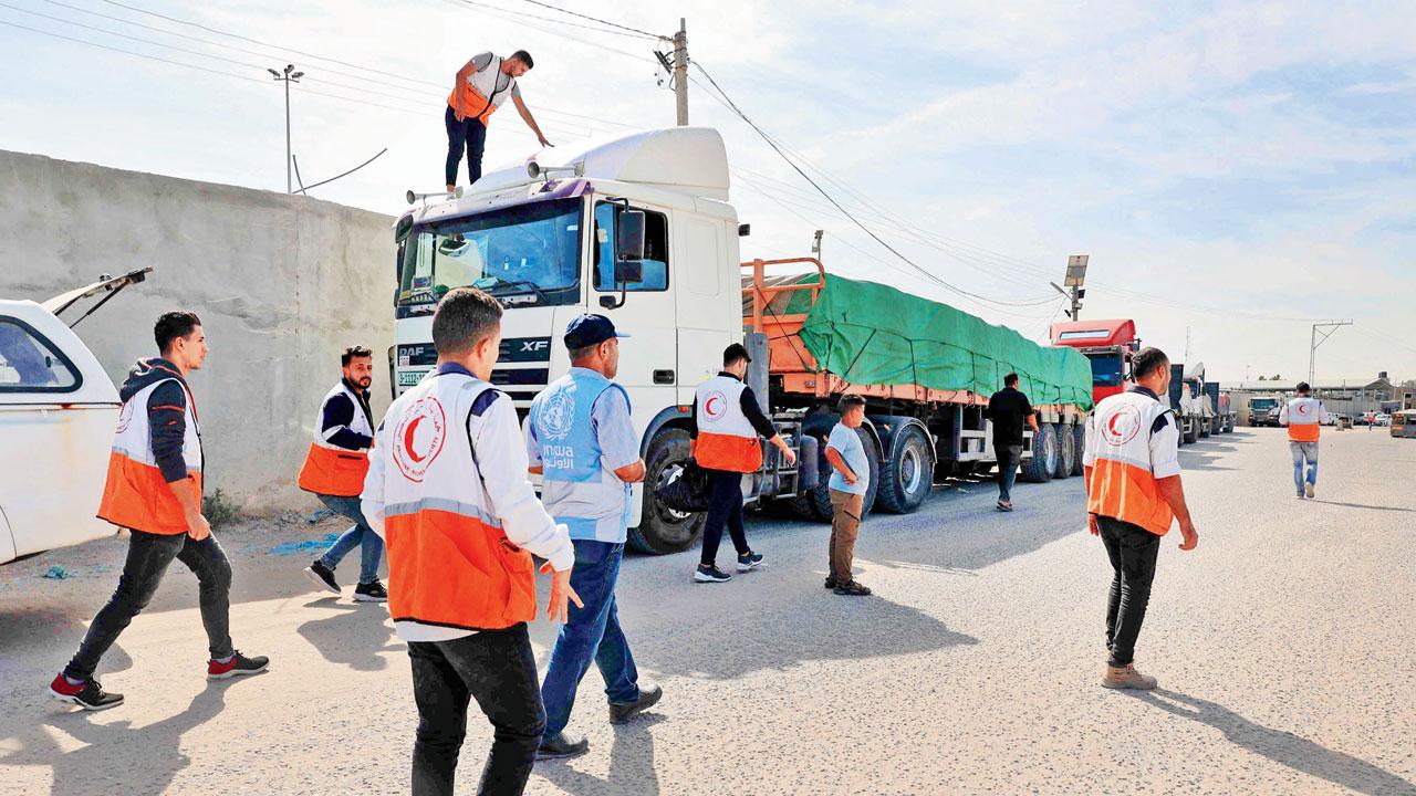Aid trucks waited at the border for days  before it was opened. Pic/PTI