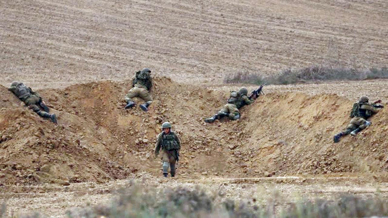 Israeli soldiers take position near the Israeli Gaza border. Pic/AP