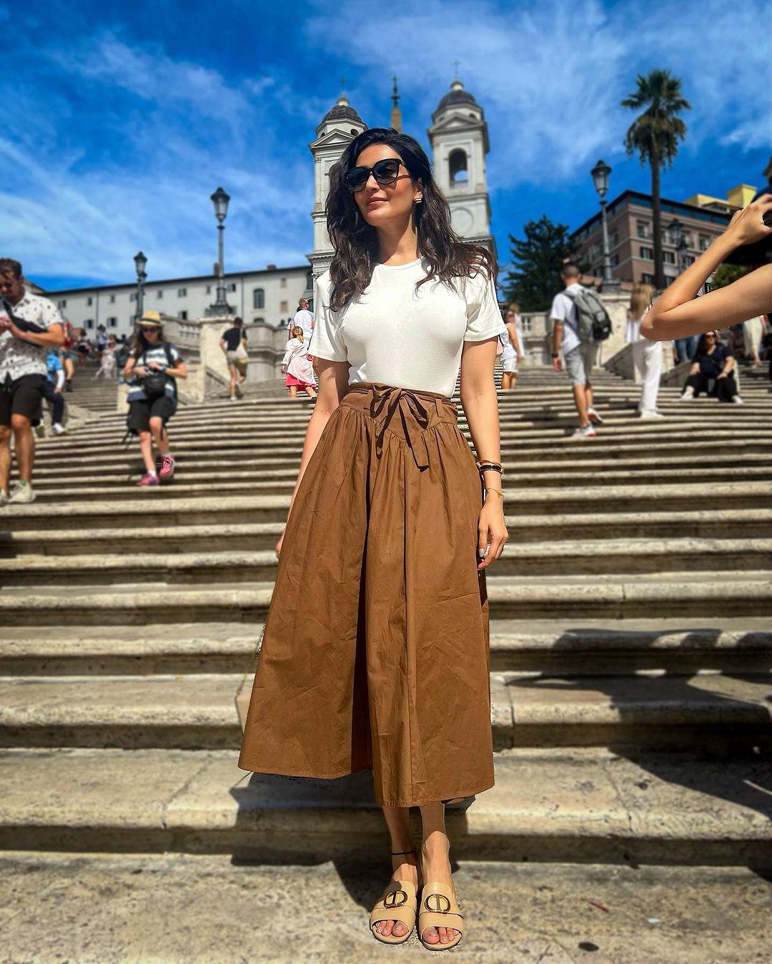 There are days when we don't feel like putting a lot of effort into our outfits, especially when it comes to our office look. Karishma Tanna's brown palazzo pants paired with a white top offer a simple yet stylish solution that can be a perfect choice for such occasions