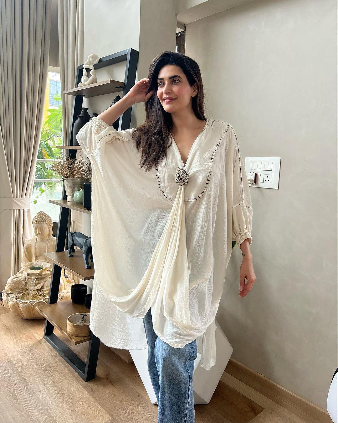 When you're not in the mood for anything else, you can always rely on traditional attire. Karishma Tanna's choice of a white stylish kurta paired with blue jeans is an absolutely perfect pick for your office look