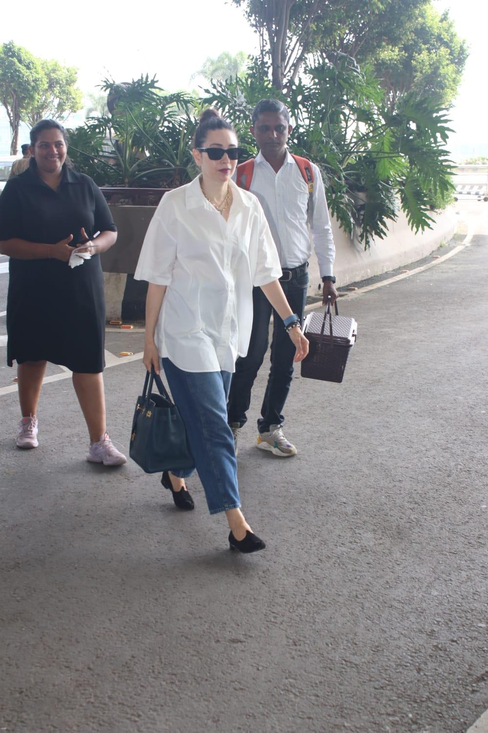 Karisma Kapoor looked stunning in a casual white shirt and blue jeans as she was snapped in the city