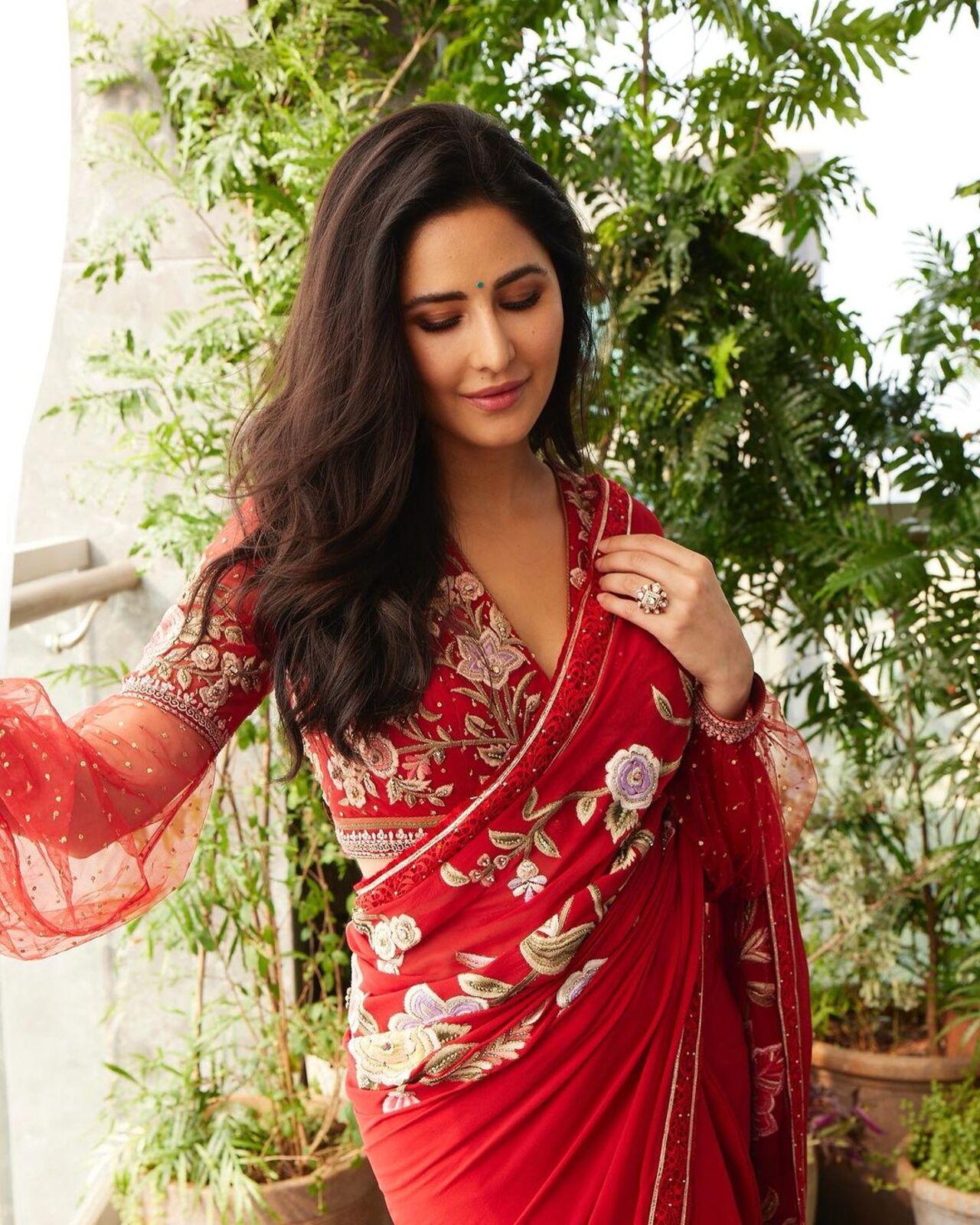 Katrina wore a red saree with floral embroidery. She paired it with a matching blouse featuring net sleeves