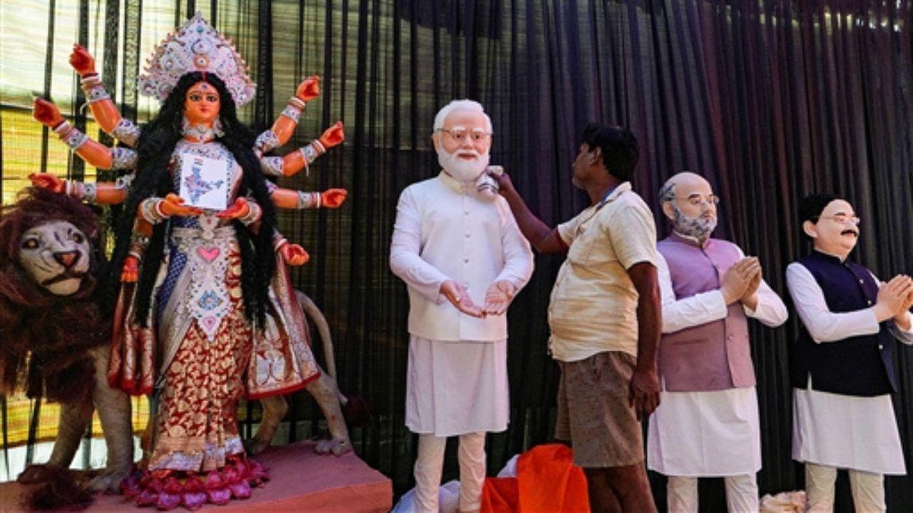 As part of the festivities, clay models of prominent figures like Prime Minister Narendra Modi, Amit Shah, and JP Nadda have been installed near a Devi Durga idol at a community puja pandal.
