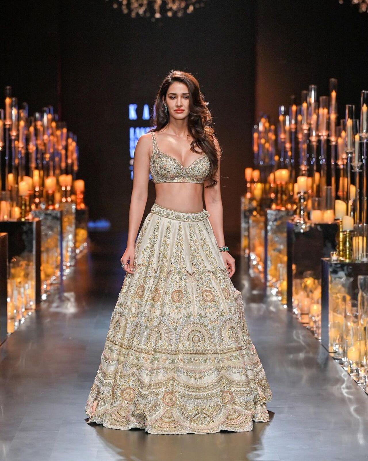 Disha Patani walked in all her glory on the ramp in a shimmery golden lehenga