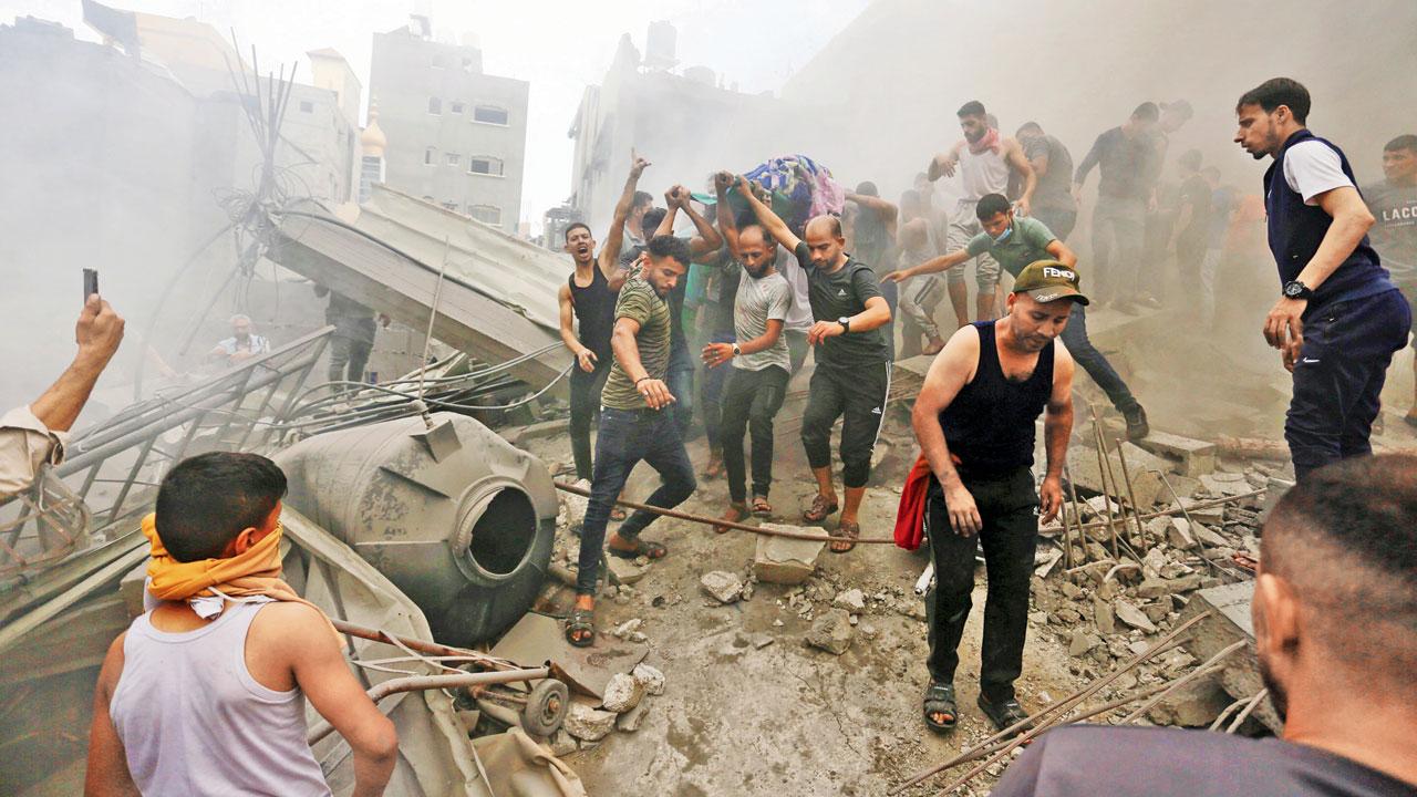 Palestinians remove bodies from rubble after an Israeli airstrike. Pic/AP