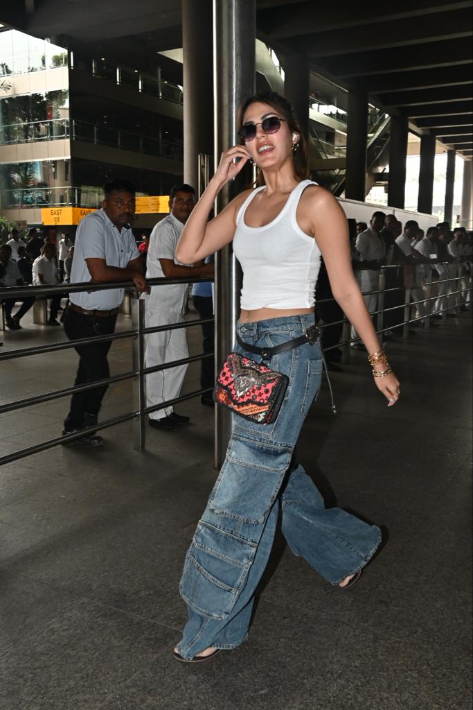 Rhea Chakraborty looked hot in a stunning white top paired with a wide-legged blue jeans