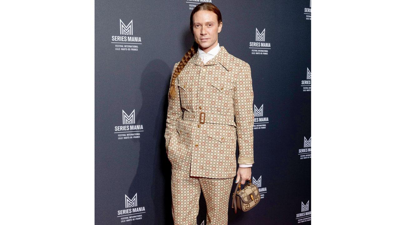 Romain Brau in a formal houndstooth pattern suit