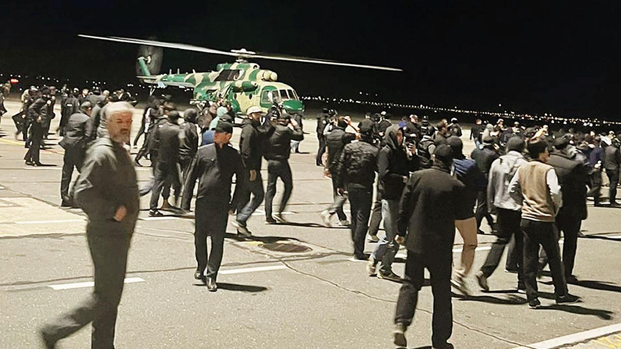 Protestors on the airfield shouting antisemitic slogans. Pic/AP