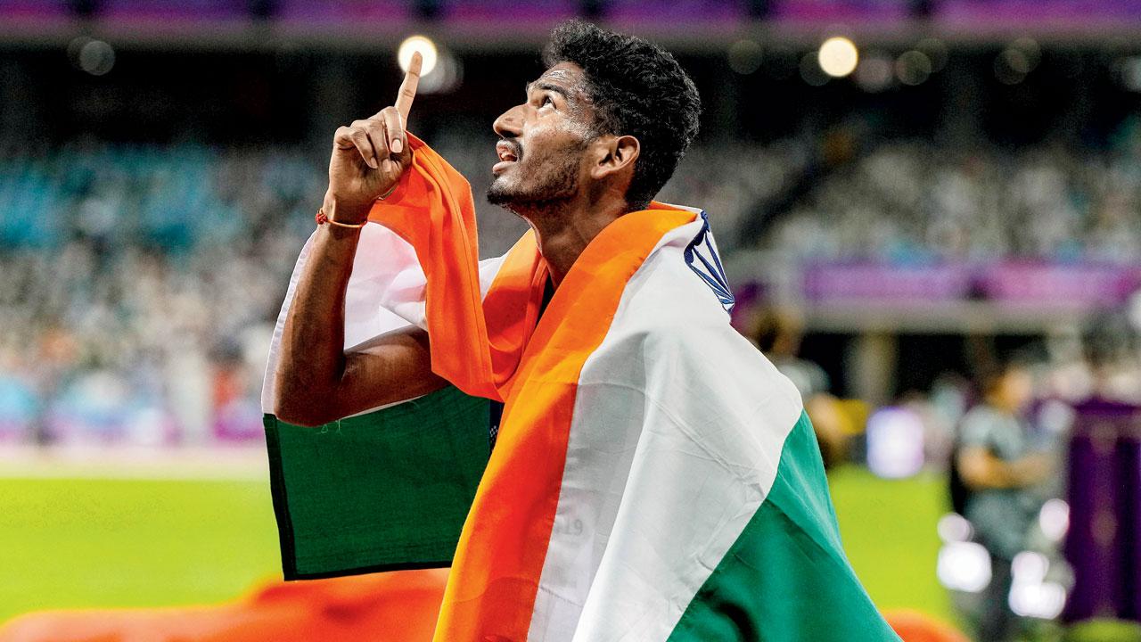 Avinash Sable celebrates his 5000m silver medal yesterday. Pic/PTI