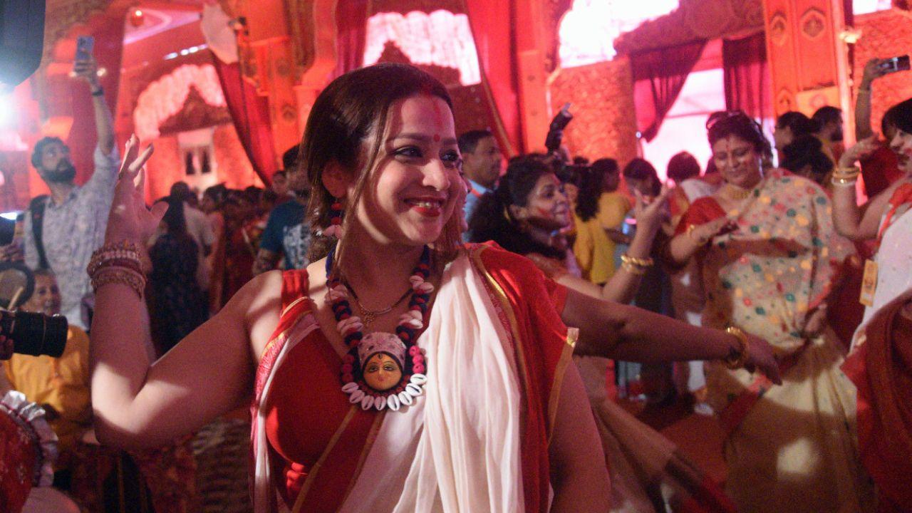 It is said that during the early celebrations, Bengali married women wanted to create a special farewell ritual for Goddess Durga and her four children. The act of smearing vermilion (sindoor) on the idols was born out of a desire to offer their love and devotion to the divine figures before their departure. 