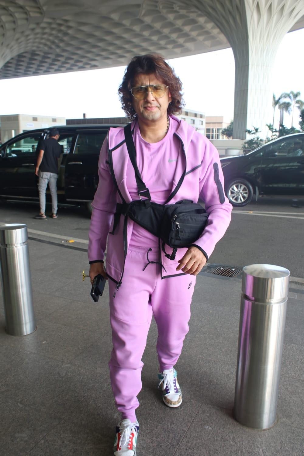 Sonu Nigam was snapped at the airport wearing a lilac colour tracksuit