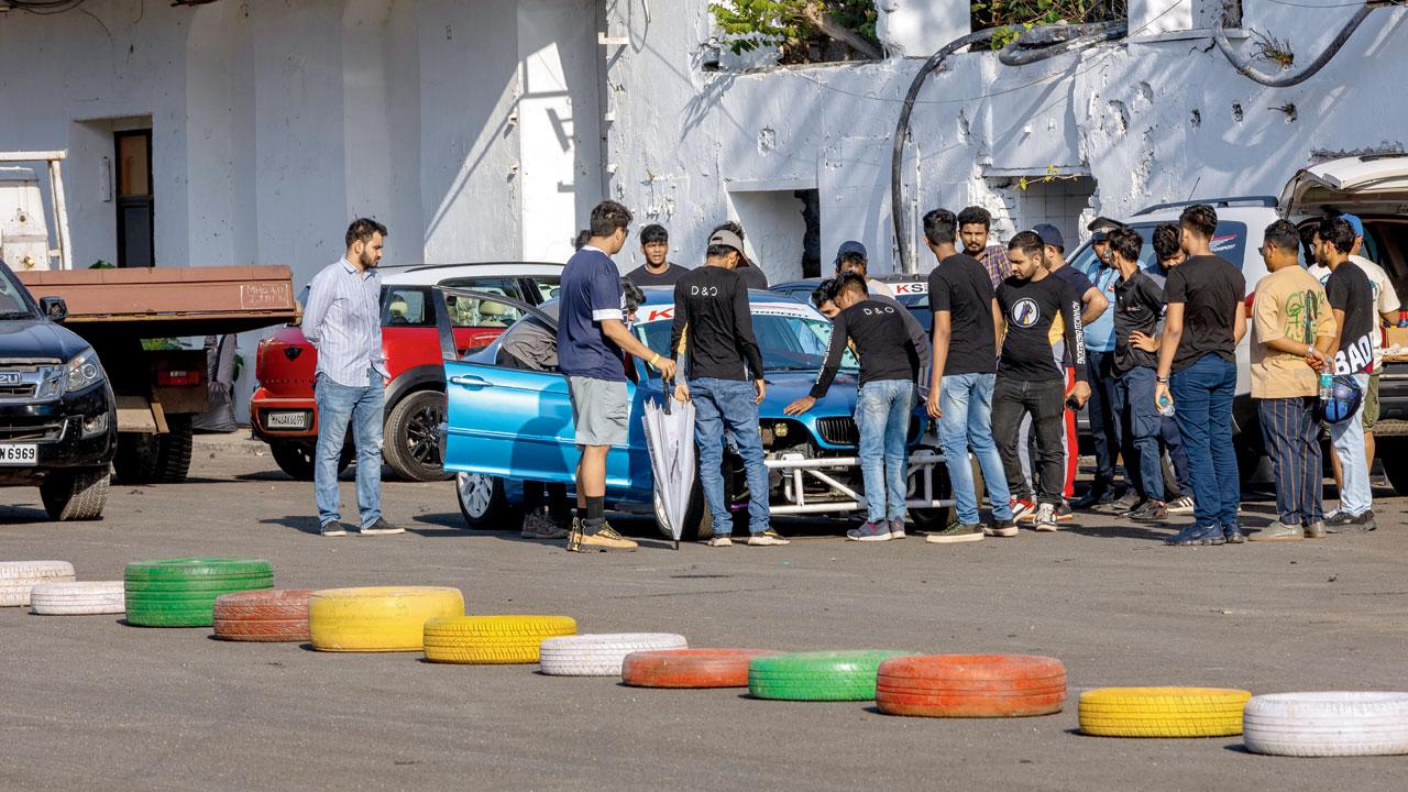 Fans examine the cars during an event