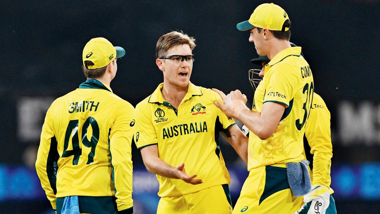 Adam Zampa (centre) celebrates a SL wicket with teammates. Pic/AFP