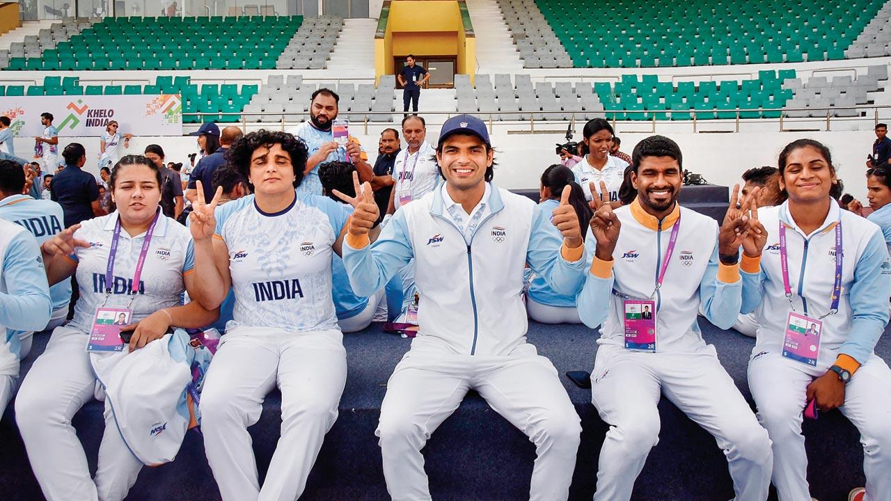 Javelin star Neeraj Chopra (centre) is all smiles at the felicitation function for Asian Games medal winners