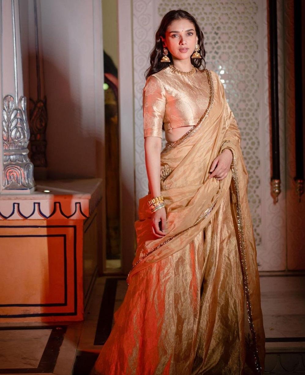 Her ensemble consists of a blouse skirt and matching dupatta with gold silk brocade embroidery.