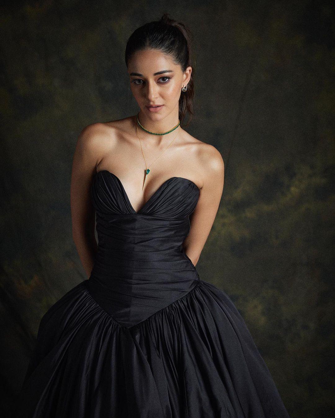 Her elegant black ball gown gives off a vintage luxury vibe.