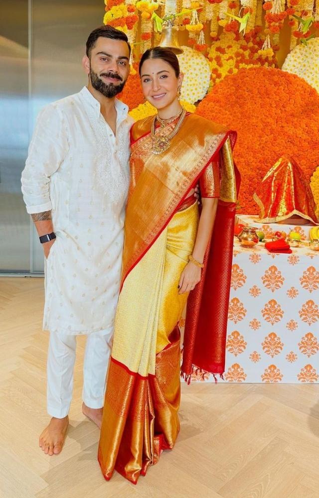 For Ganesh Chaturthi this year, Anushka Sharma wore a lovely off-white and orange silk saree. She completed her look with gold jewellery