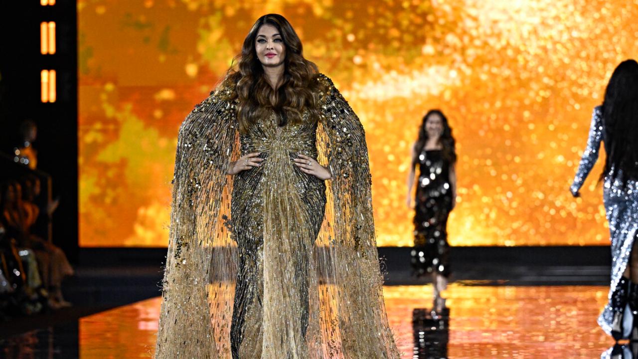 Aishwarya stunned in a sparkly gold shimmery cape gown and debuted her blond highlights. The fashion event was held by Eiffel Tower and Rai Bachchan was among the showstoppers