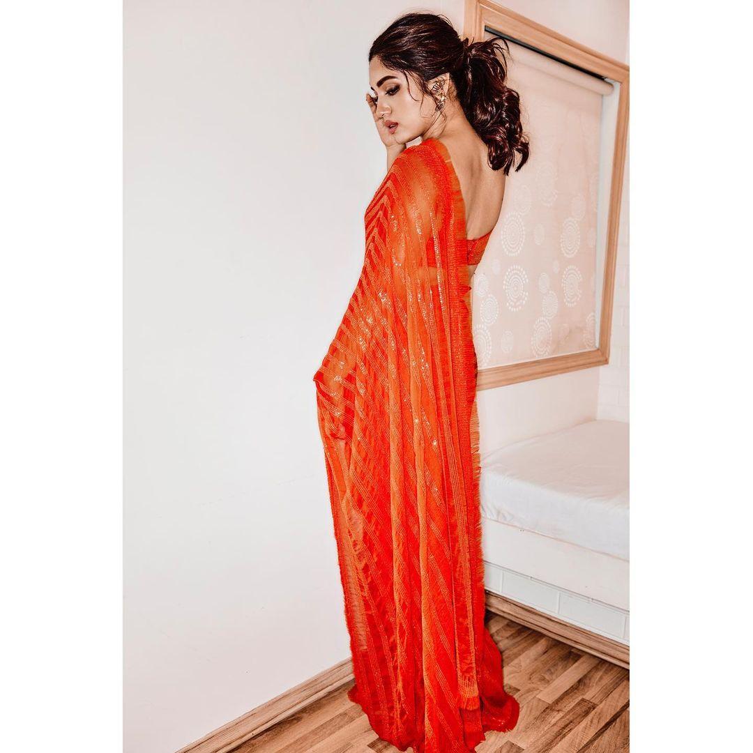 This eye-catching Manish Malhotra creation in candy orange suited her impeccably. The actor appeared truly fabulous, and the saree's color makes it a perfect choice for celebrating Navratri.