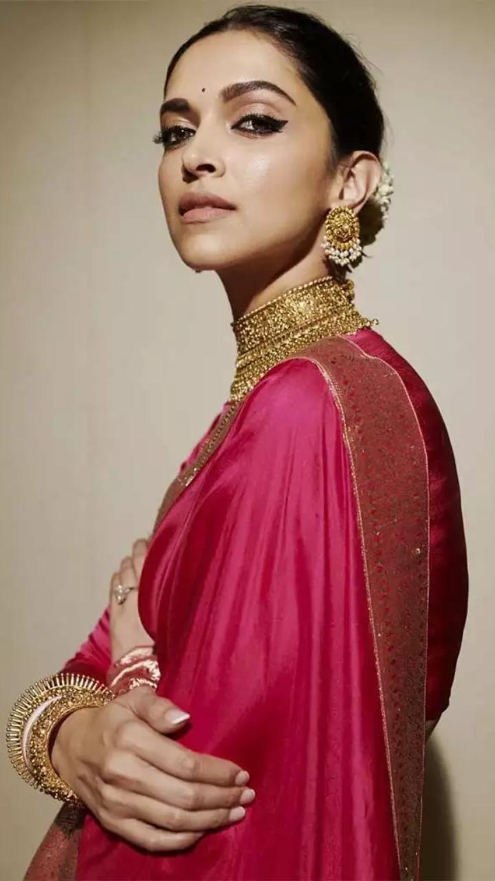 Day 9 (Pink): Deepika Padukone wore a deep pink saree. The actress matched her outfit with a gold choker and statement earrings. Her hair was done in a neat bun