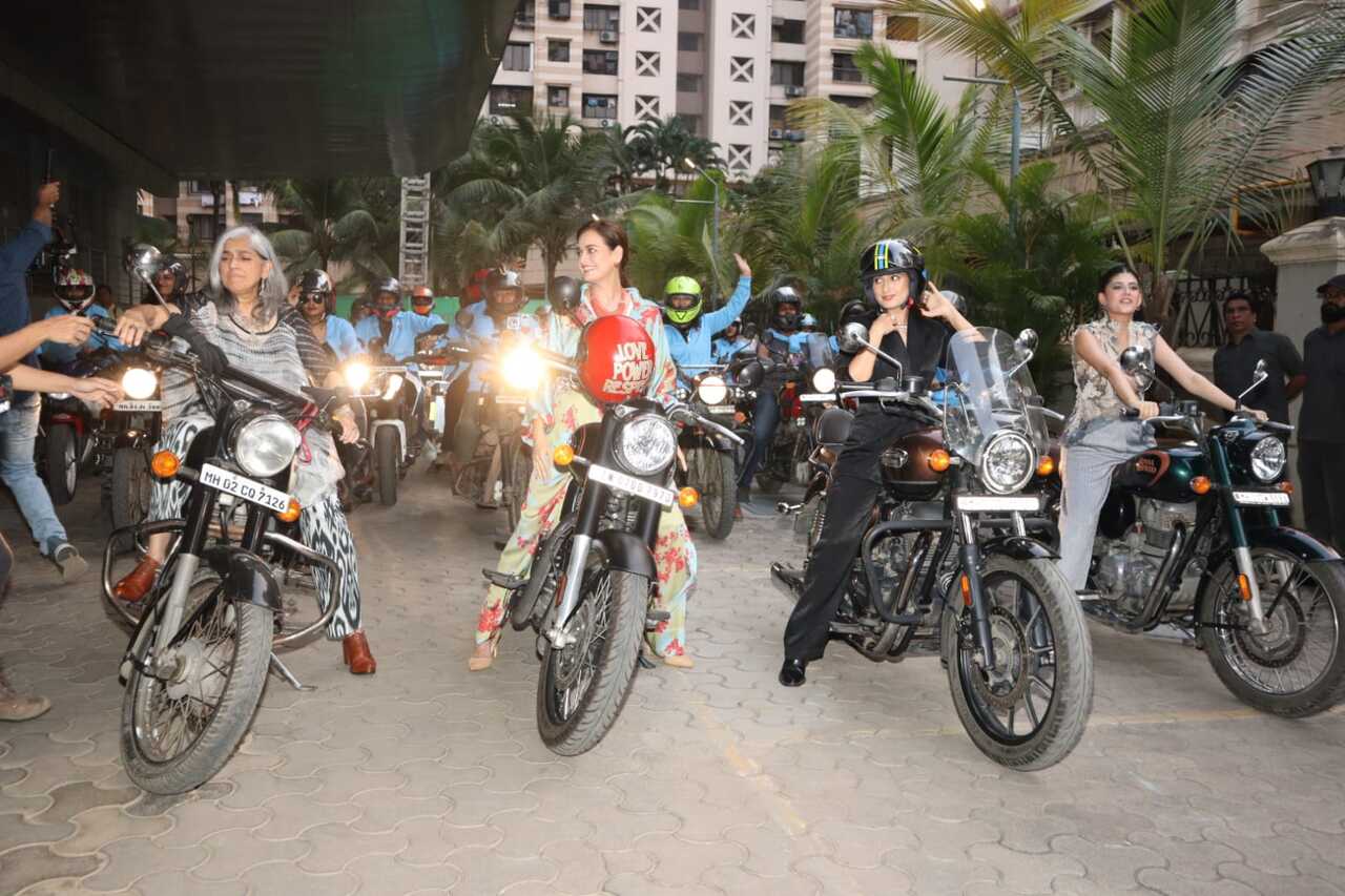 The co-stars rode a bike at the event