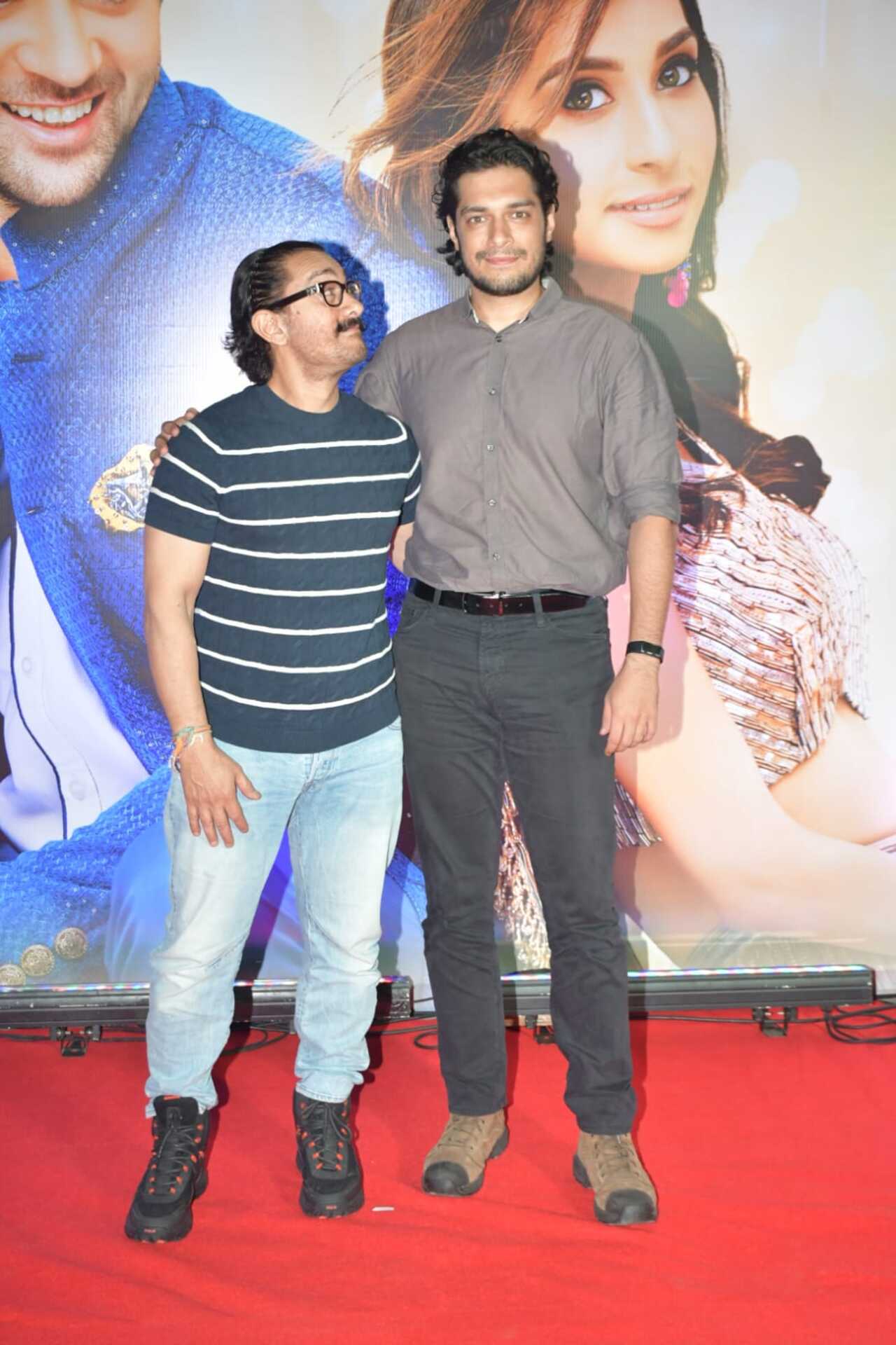 Aamir Khan looks up to his son as they pose together for the camera