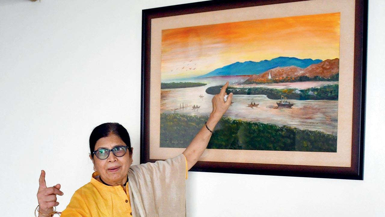 Tirodkar points out to the hillocks that inspired this painting by a local artist; the hills have now been razed to the ground due to the ongoing airport work. The blasting has increased the dust inside their house