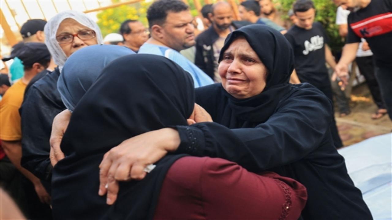 Fifteen members of the same family were among at least 33 Palestinians buried in a mass grave at a Gaza hospital on Monday after they were killed by Israeli airstrikes.