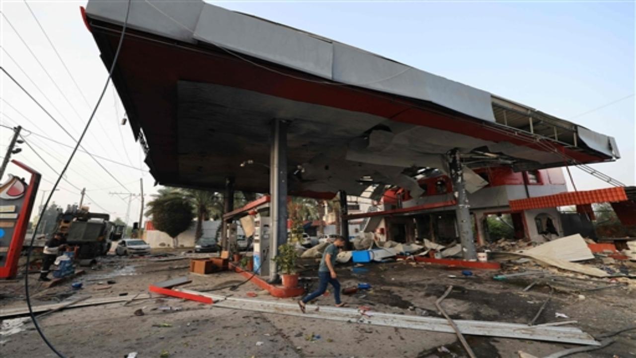 Side-by-side, the bodies were laid to rest in a shallow, sandy grave in the courtyard of al-Aqsa Hospital in Deir al-Balah, an ambulance parked nearby. 