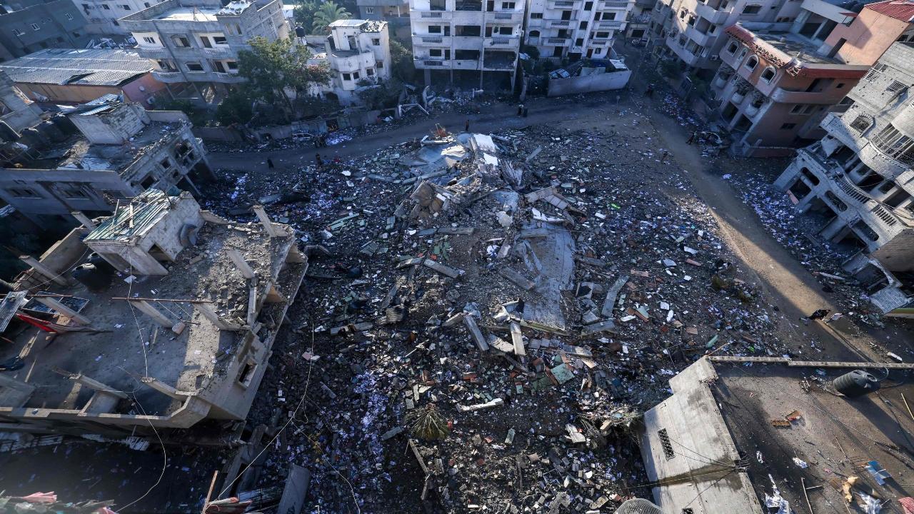 Palestinians inspect the damage after an Israeli airstrike in the Rafah refugee camp in the southern of Gaza Strip, on October 16, 2023. Israel declared war on the besieged Gaza on October 8. (Photo by MOHAMMED ABED/AFP)