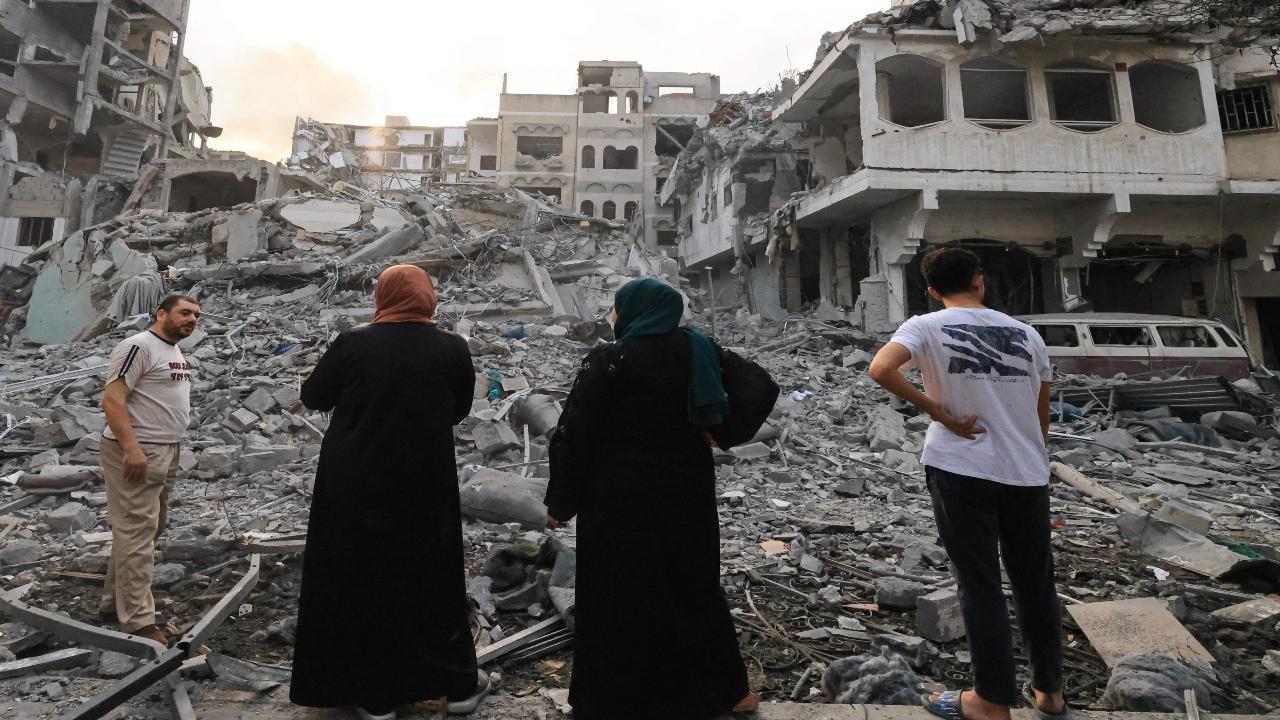 Palestinians inspect the massive destruction following Israeli airstrikes on Gaza City's al-Rimal district, on October 10, 2023. Israel kept up its deadly bombardment of Gaza on October 10. AFP