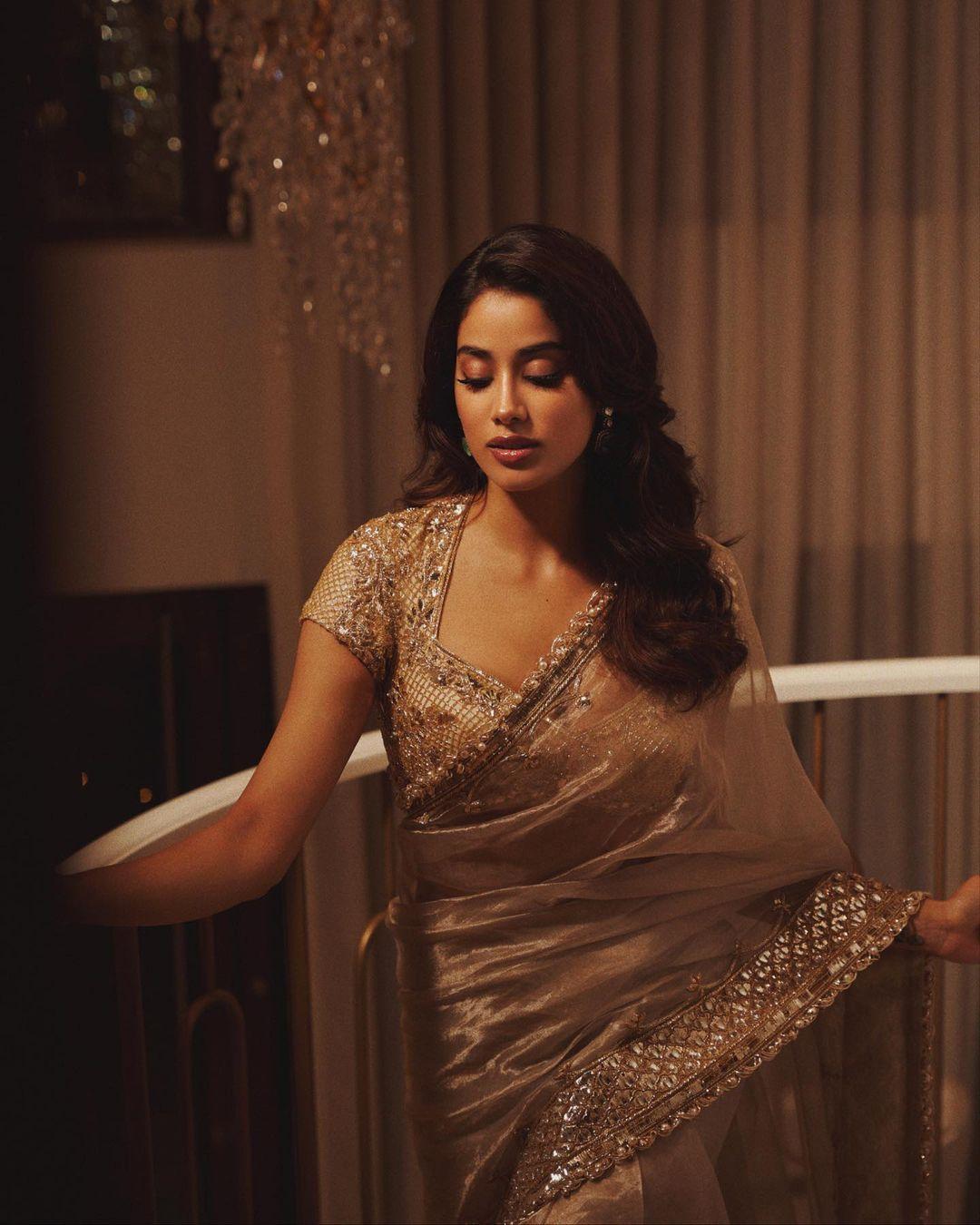 Janhvi Kapoor opted for a golden saree paired with a matching blouse, making a statement with her contrast earrings and bold lips.