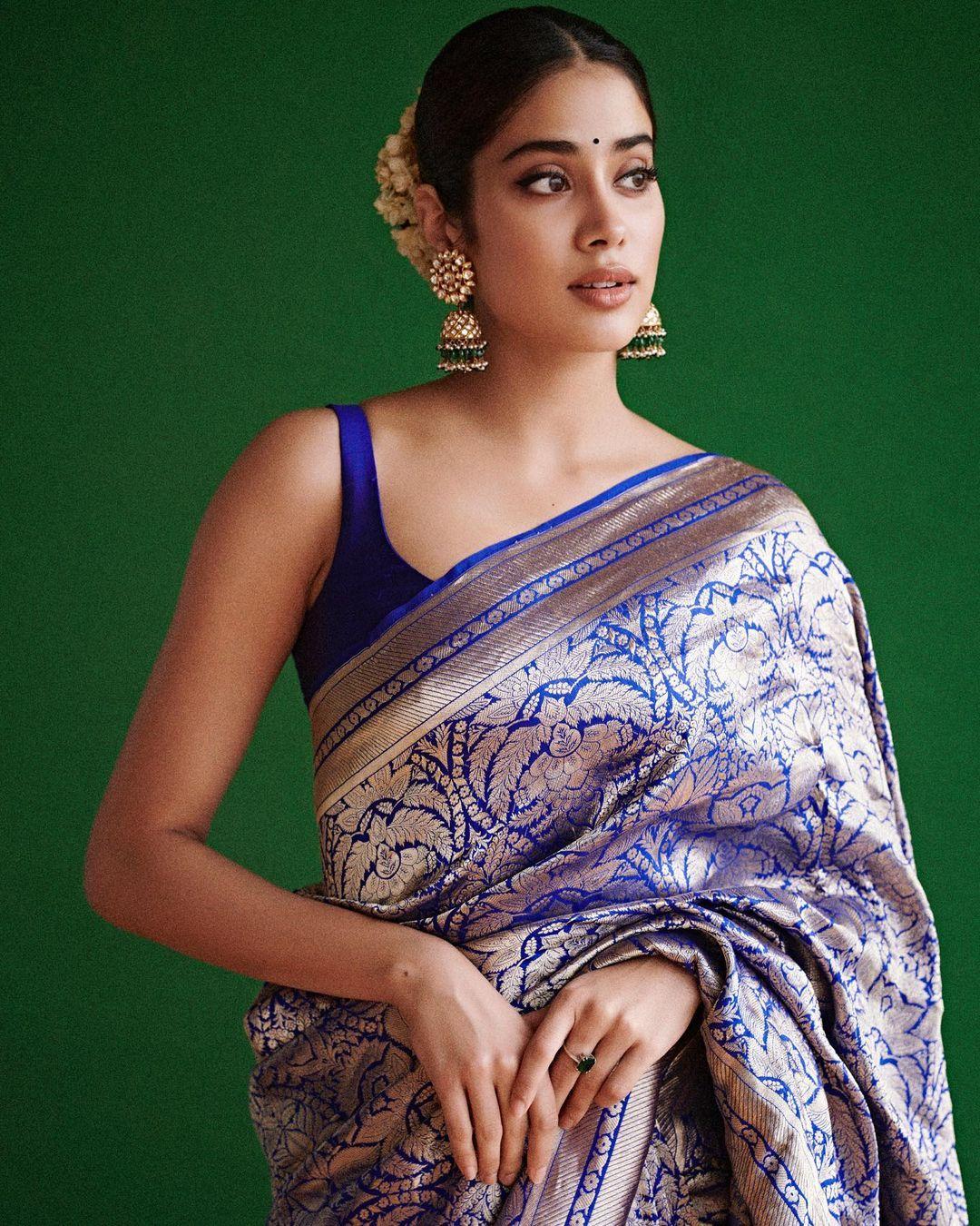 If you're looking for the perfect Navami outfit, Janhvi Kapoor's choice of a stunning navy blue silk saree, adorned with intricate embroidery and wide, silvery borders could be the one for you. This saree not only catches the eye but also serves as an exceptional choice for the occasion.