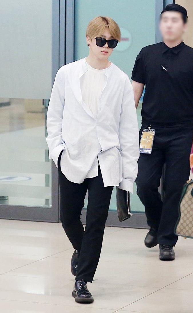 Jimin knows the power of monochrome. In one picture, he wears a white shirt and an additional white overshirt, proving that simplicity can be incredibly stylish.