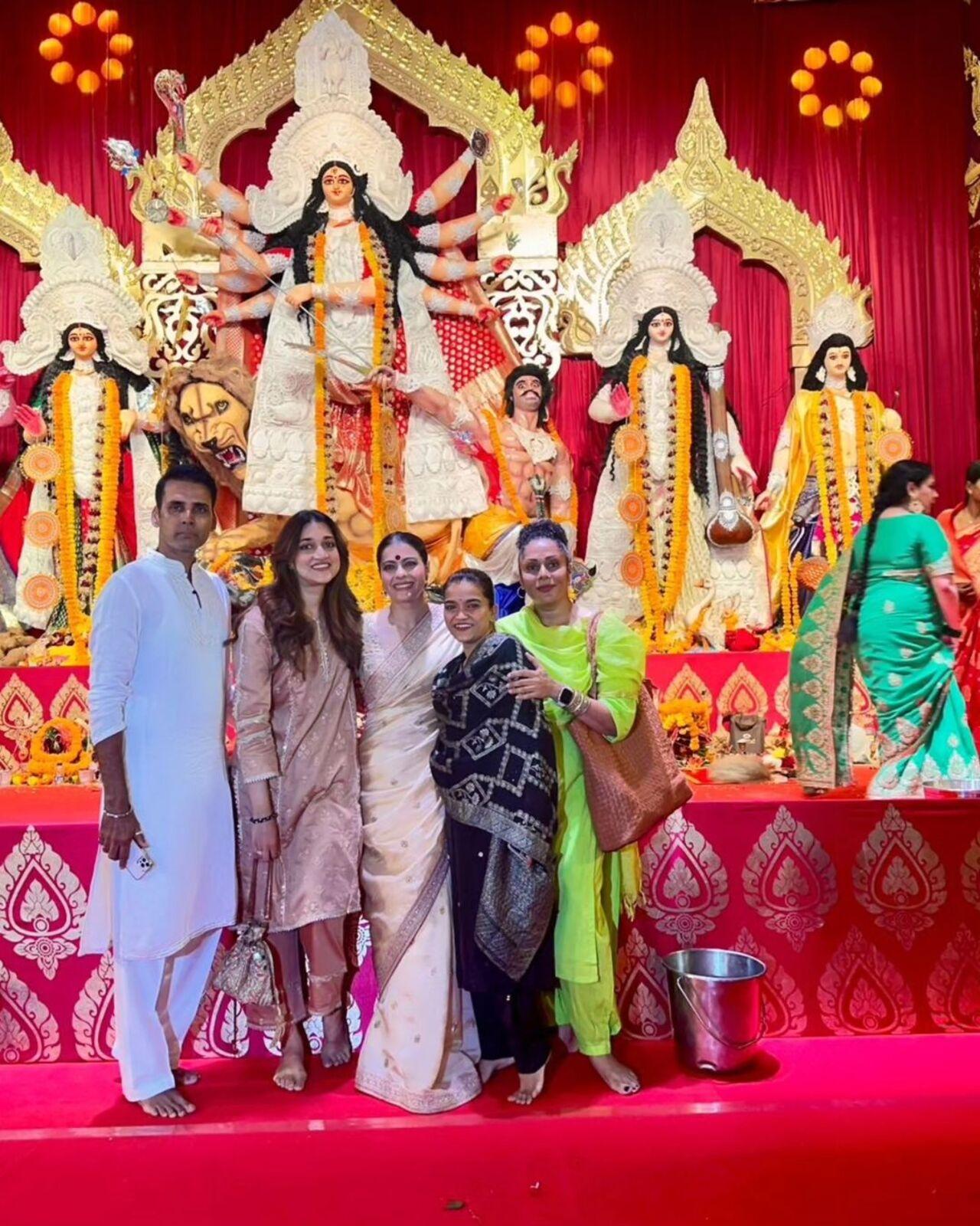 Kajol poses with family members at the pandal