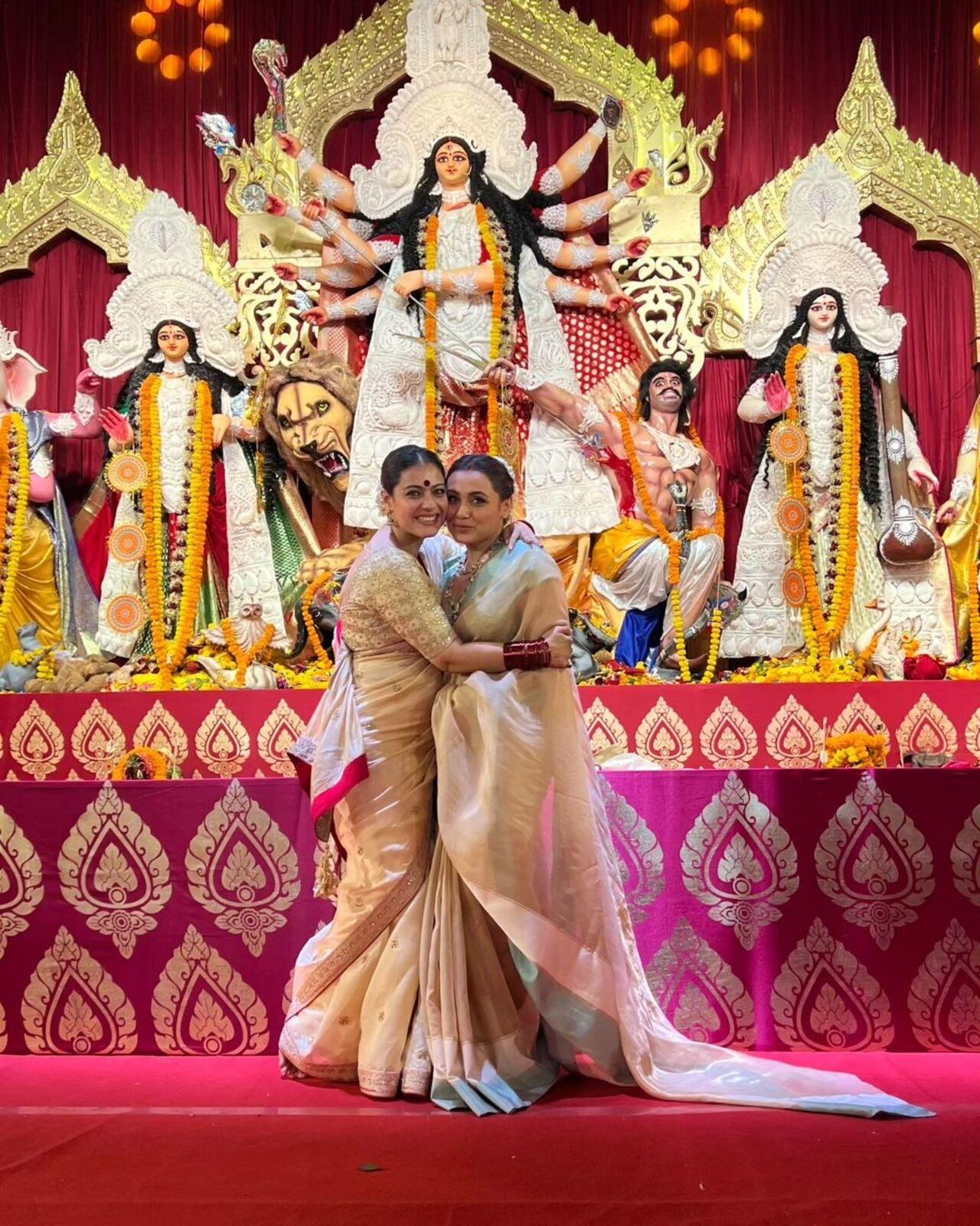 Kajol poses with her cousin actress Rani Mukerji in front of Durga maa. The cousins are regular at the pandal and take part in all festivities