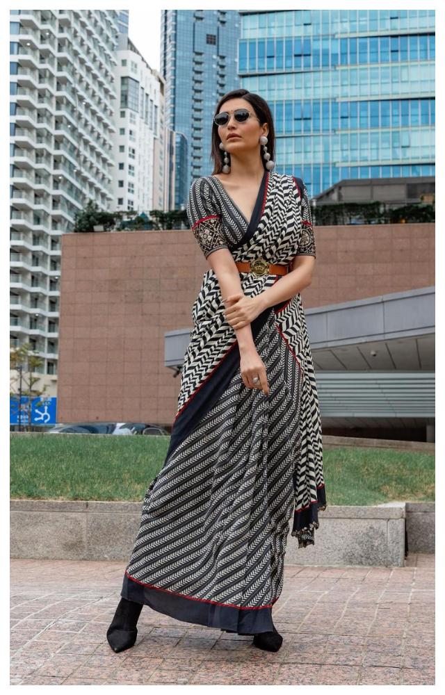 Karishma shared a bunch of photos as she went out and about on the streets of Busan in a black and grey striped saree